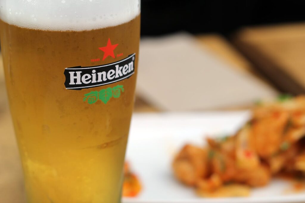 pexels-photo-70598 Chilled Heineken beer with a side of delicious snacks on a sunny day.